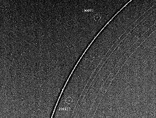 Voyager 2 has discovered two "shepherd" satellites associated with the rings of Uranus. The two moons -- designated 1986U7 and 1986U8 -- are seen here on either side of the bright epsilon ring; all nine of the known Uranian rings are visible. Image credit: NASA/JPL