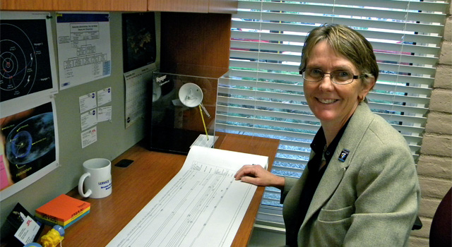 Suzanne Dodd is the new project manager for NASA's Voyager spacecraft. She first worked on Voyager in 1984, sequencing science and engineering commands for Voyager 1 and 2 in 1984. A memento of those early years is a sheet of vellum that shows the timeline of commands communicated to Voyager 2 during its closest approach to Neptune on Aug. 25, 1989. Image credit: NASA/JPL-Caltech