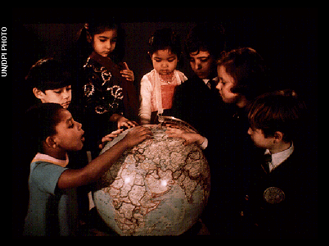 The children with globe image is one of the pictures electronically placed on the phonograph records which are carried onboard the Voyager 1 and 2 spacecraft. Credit: UN/DPI Photo