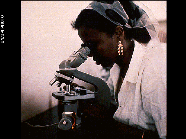 The woman with microscope image is one of the pictures electronically placed on the phonograph records which are carried onboard the Voyager 1 and 2 spacecraft. Credit: UN/DPI Photo