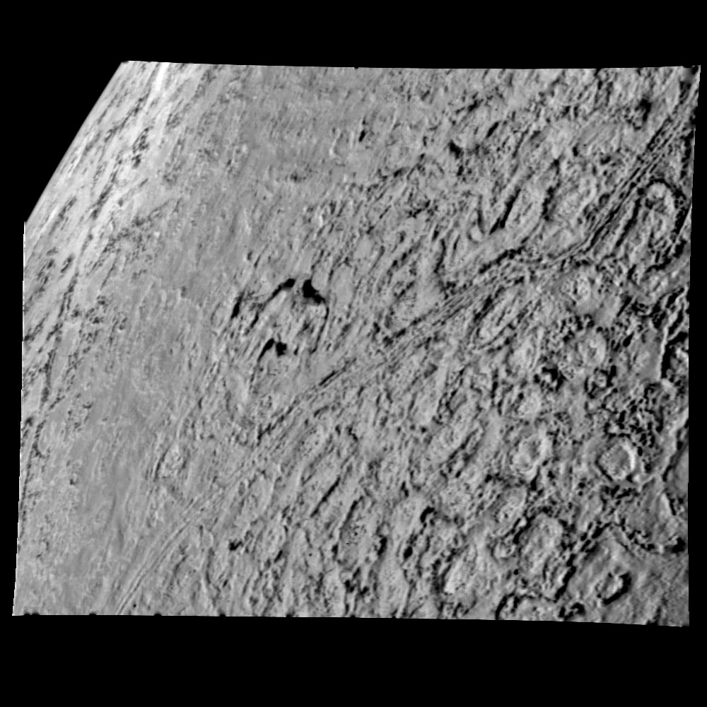 Triton from 25,000 miles. Depressions may be caused by melting and collapsing of icy surface.