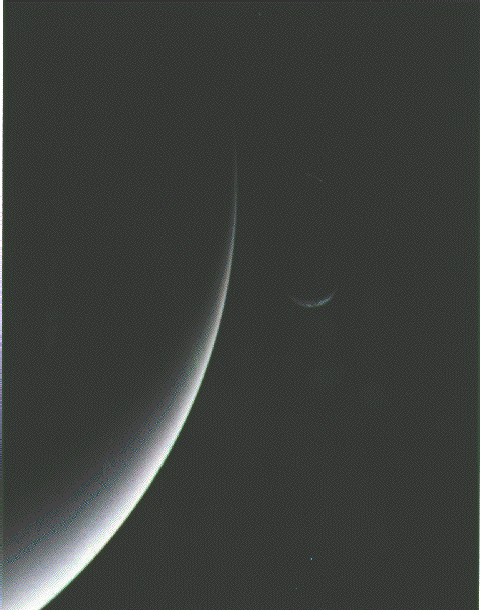 Parting view of Neptune and moon Triton.