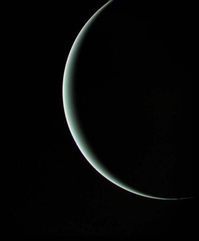 Farewell shot of crescent Uranus as Voyager 2 departs. January 25, 1986. Range 600,000 miles.